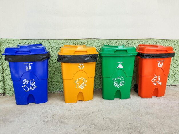 Photo multi colored garbage bin against wall