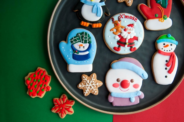 Multi colored gingerbread cookies during christmas in plate