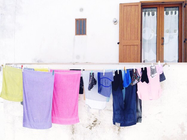 Photo multi colored laundry hanging outside house