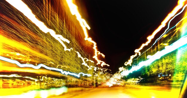 Photo multi colored light trails on street at night