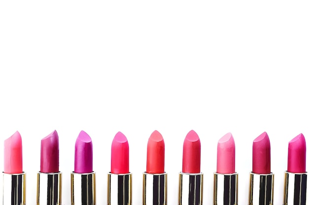 Multi-colored lipstick on white background