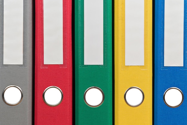 Multi-colored office folders to store documents standing next to each other, close-up