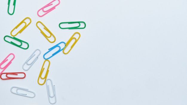 Photo multi-colored paper clips on a white background.