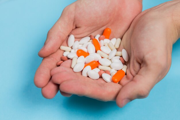 Multi-colored pills in hands