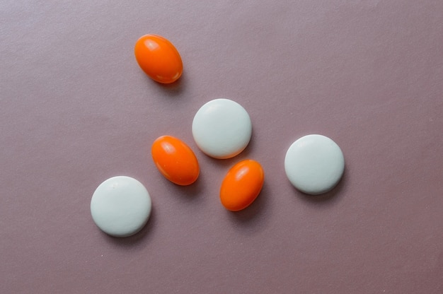 Multi-colored pills and vitamins in capsules. top view