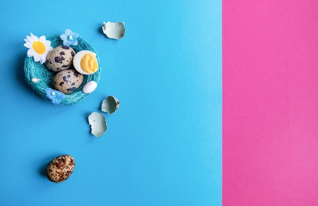 Multi-colored pink and blue background with quail eggs in a basket