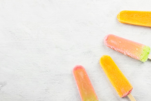 Photo multi-colored popsicles on a white background.