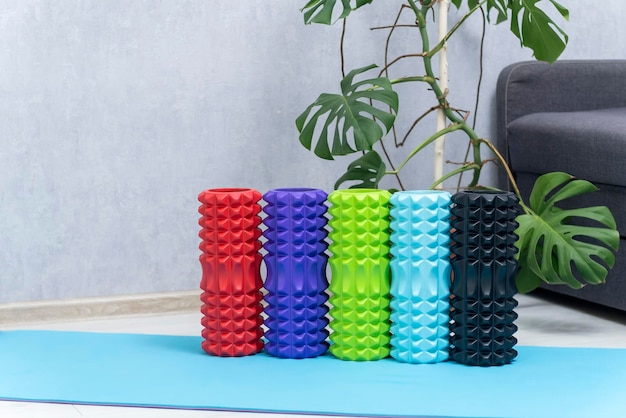 Multi-colored rollers for self-massage. Myofascial foam roller. Fitness Equipment. Myofascial release.