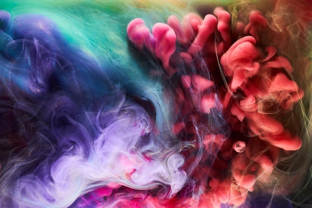 複数の色の輝く抽象的な背景高級ダークゴールド煙アクリル塗料水中爆発宇宙渦巻くインク