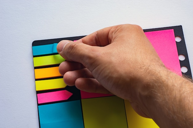 Multi-colored stickers for notes of different sizes and shapes with a marker.