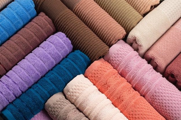 multi-colored terry towels rolled up and laid out in a row on the table