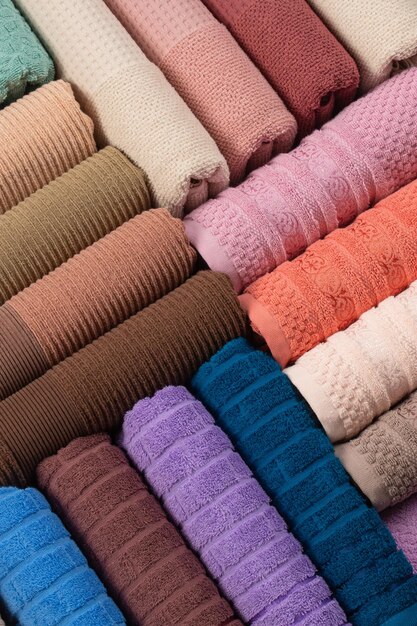 multi-colored terry towels rolled up and laid out in a row on the table