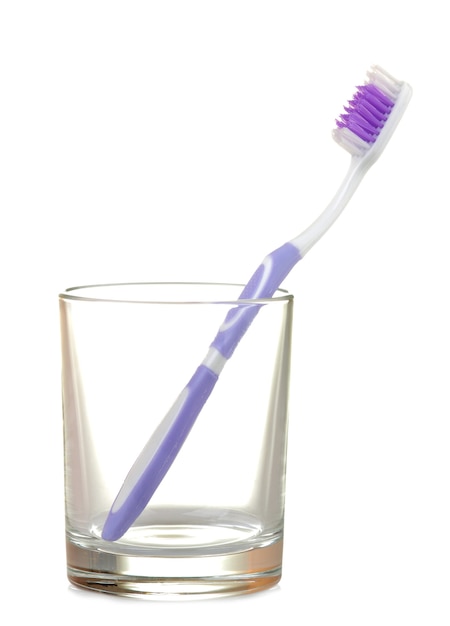 Multi-colored toothbrushes in a glass beaker on a white isolated. Oral hygiene.