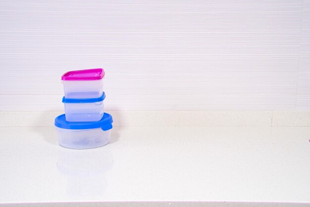 multi colored tupperware on white background