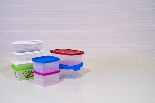 multi colored tupperware on white background