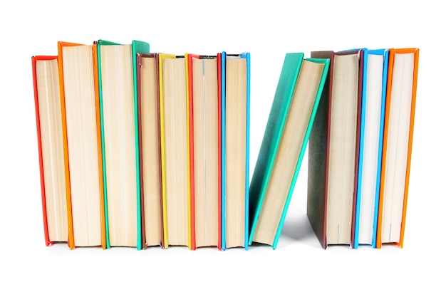 Multi-coloured books. On a white table.