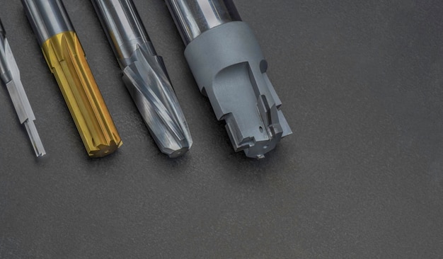 Multi cutting tools special set drill endmill reamer cutter\
material carbide used for metalwork isolated on dark\
background