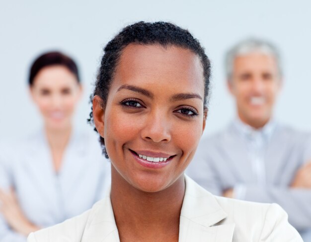 Multi-ethnic business people standing with folded arms 