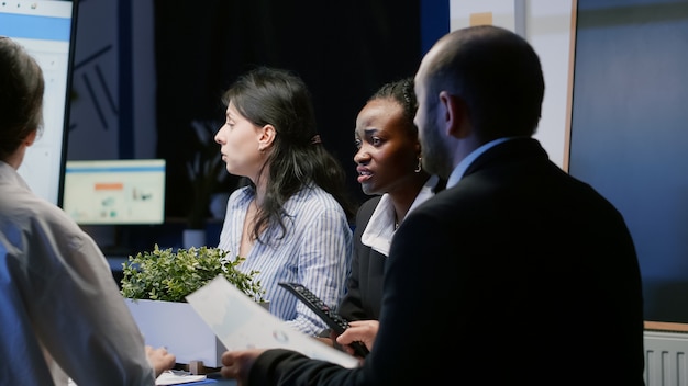 Multi ethnic businesspeople working in company meeting office room