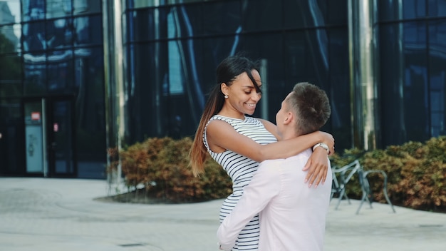 Multi-ethnic couple in love spending time together in the center of the big city