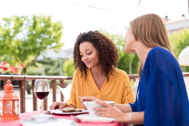 Multi-Ethnic friends talking and having fun at bar's balcony