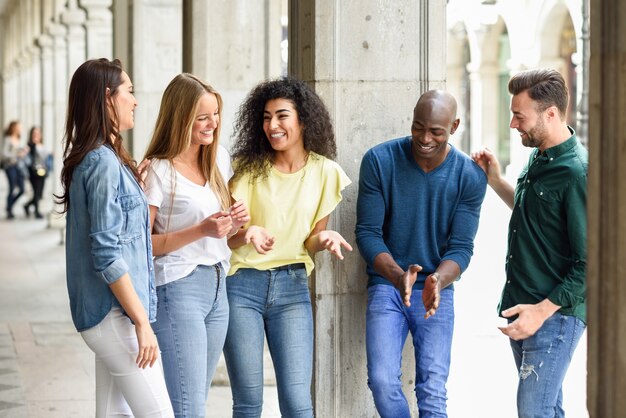 multi-ethnic group of friends having fun together in urban background