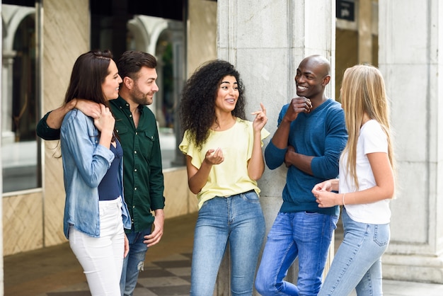 multi-ethnic group of friends having fun together in urban background