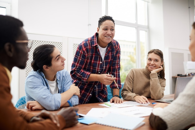 Multi-Ethnic Group of Students Discussing Project