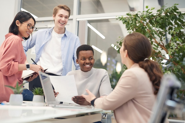 Multi-ethnic group of young business people discussing work project