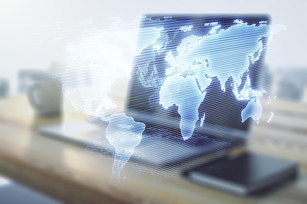 Multi exposure of abstract creative digital world map and modern desktop with laptop on background research and analytics concept
