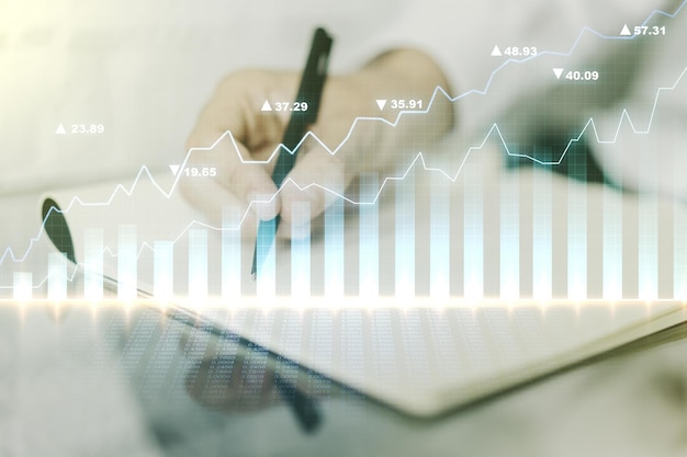 Multi exposure of abstract creative financial chart with hand writing in diary on background research and analytics concept