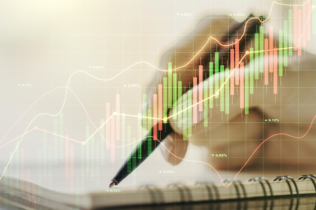 Multi exposure of abstract creative financial graph with hand writing in notepad on background forex and investment concept