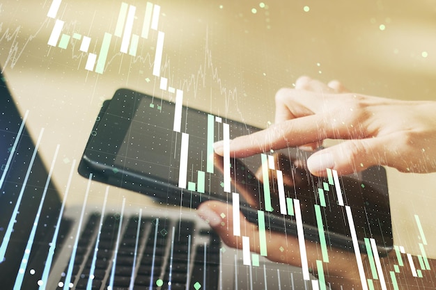 Multi exposure of abstract financial diagram and hand working with a digital tablet on background banking and accounting concept