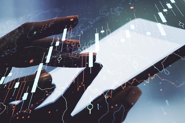 Multi exposure of abstract financial diagram with world map and hand working with a digital tablet on background banking and accounting concept