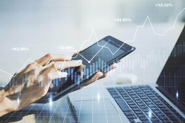 Multi exposure of abstract financial graph and hand working with a digital tablet on background financial and trading concept