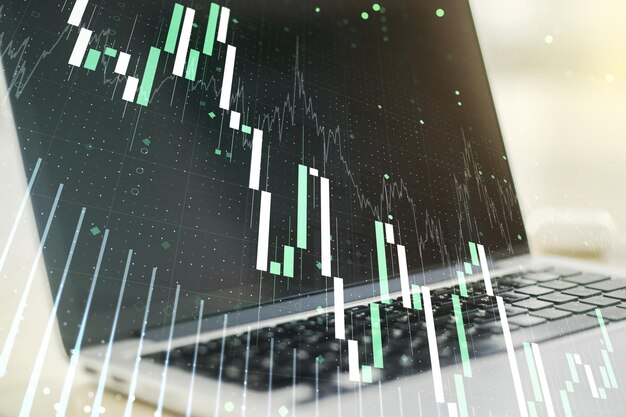 Multi exposure of abstract financial graph on laptop background financial and trading concept