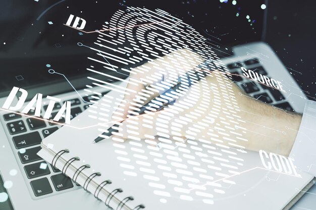 Multi exposure of abstract fingerprint scan interface with hand writing in notepad on background with laptop digital access concept