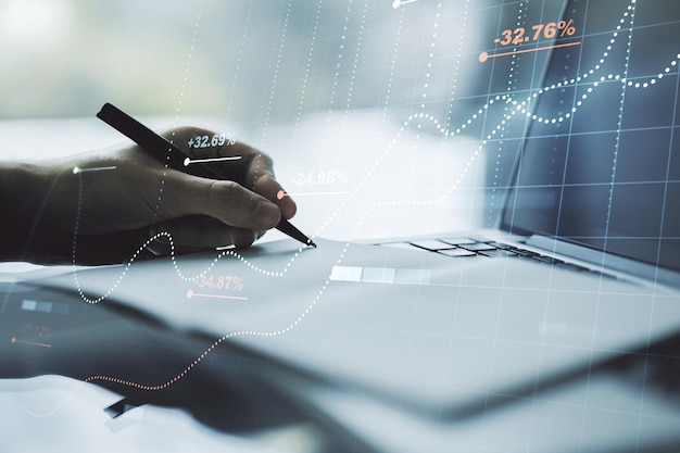 Multi exposure of abstract statistics data hologram interface with hand writing in notepad on background with laptop computing and analytics concept
