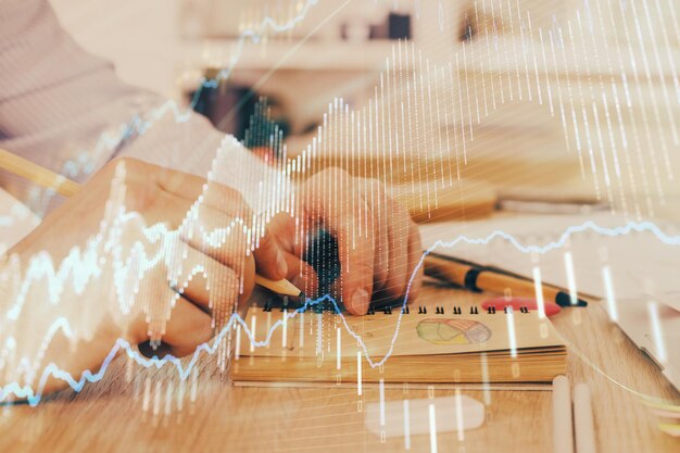 Multi exposure closeup hands with stock market forex graph Concept of research and analysis