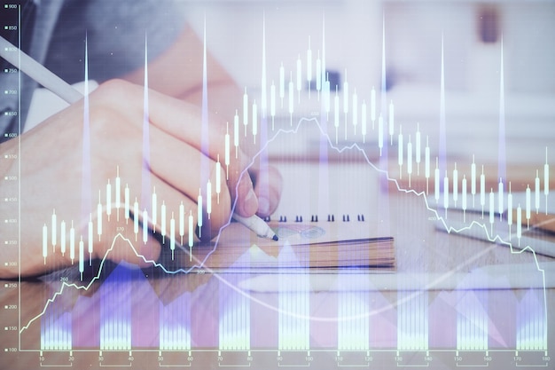 Multi exposure closeup hands with stock market forex graph