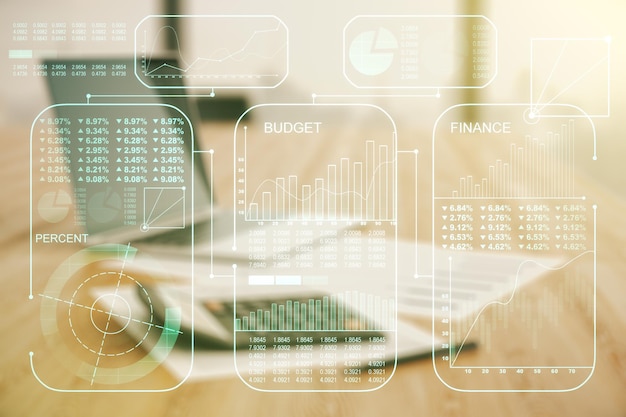 Multi exposure of creative statistics data hologram on blurry calculator with laptop background stats and analytics concept