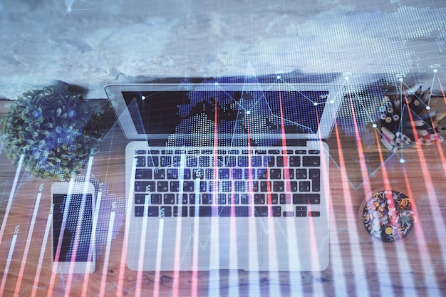 Multi exposure of financial chart drawing over table background with computer Concept of research and analysis Top view