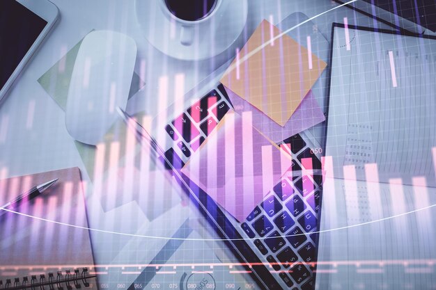 Multi exposure of financial chart drawing over table background with computer Concept of research and analysis Top view