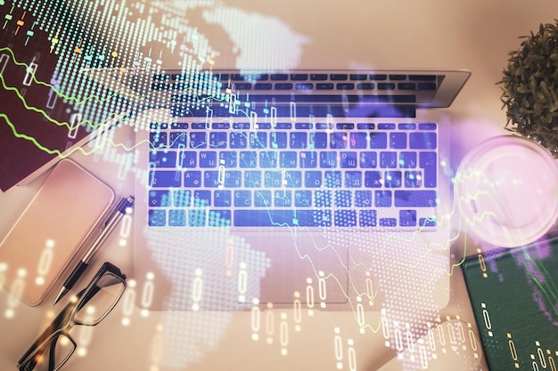 Multi exposure of financial chart drawing over table background with computer Concept of research Top view