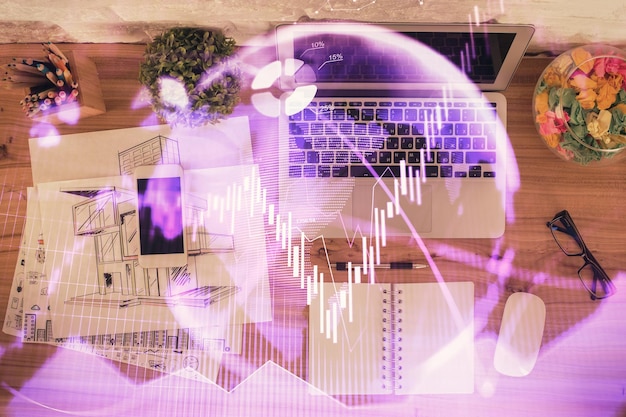 Photo multi exposure of financial chart drawing over table background with computer concept of research top view