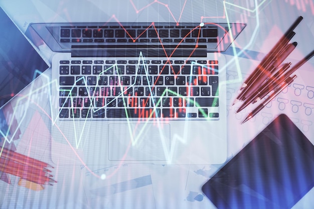 Multi exposure of forex chart drawing over table background with computer Concept of financial research and analysis Top view