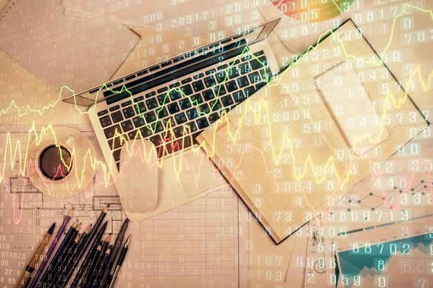 Multi exposure of forex chart drawing over table background with computer Concept of financial research and analysis Top view