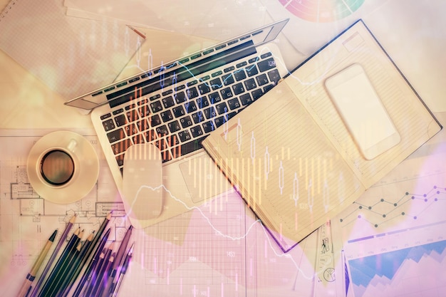 Multi exposure of forex chart drawing over table background with computer Concept of financial research and analysis Top view