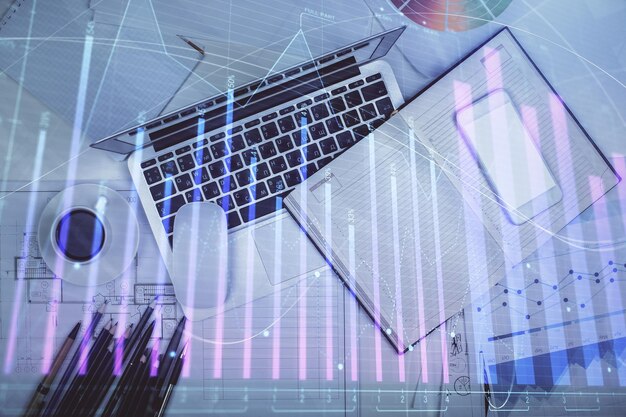 multi exposure of forex chart drawing over table background with computer concept of financial research and analysis top view