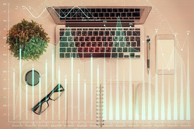 multi exposure of forex chart drawing over table background with computer concept of financial research and analysis top view